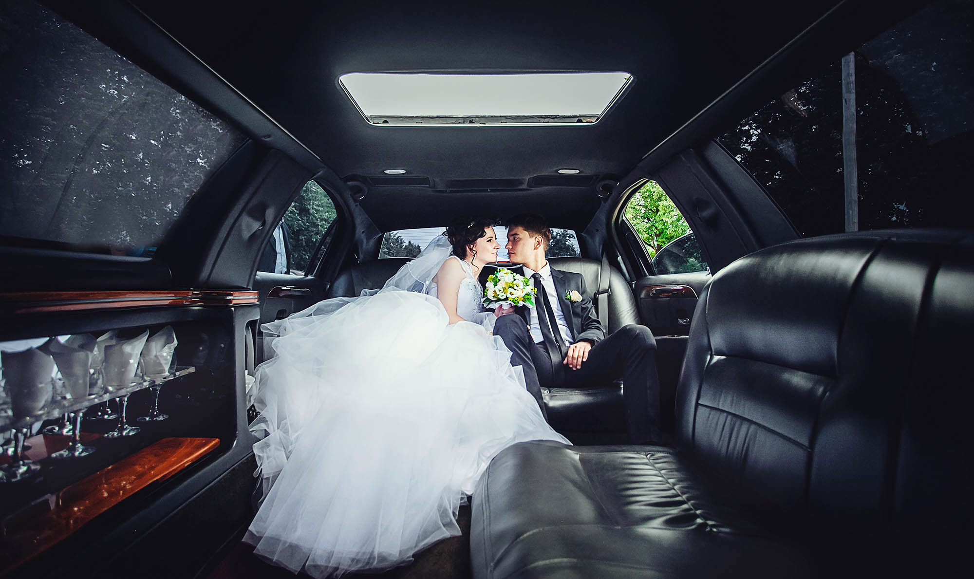 Bride and groom sitting in our stretch wedding limo