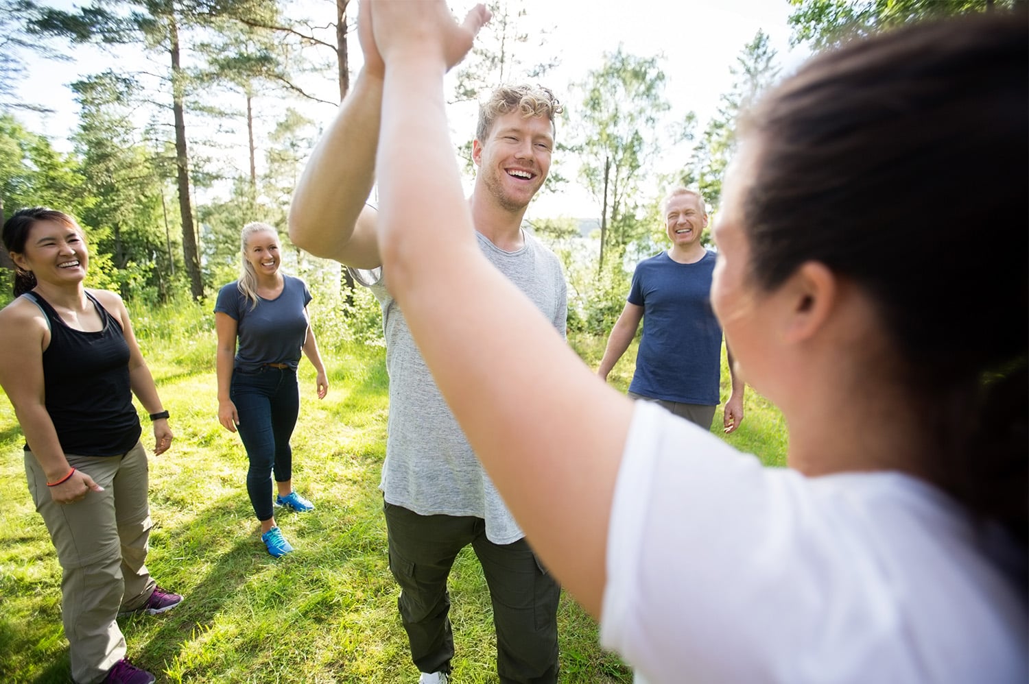 Coworkers participating in team bonding activities, high-fiving each other.